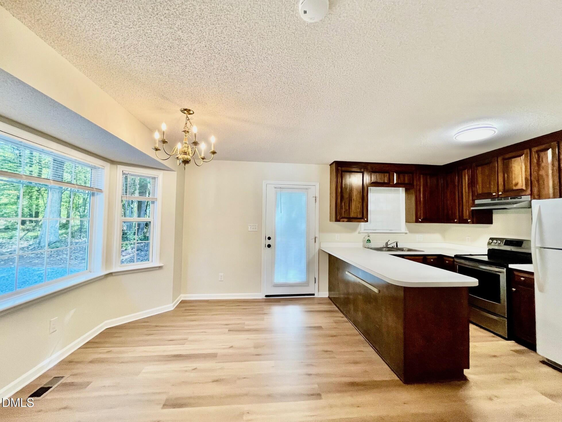 5413 Passenger Place Raleigh, NC 27603 - Photo 6 of 16 a large kitchen with stainless steel appliances granite countertop a large counter top and stove