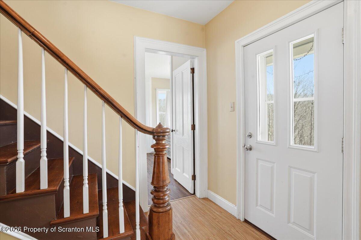 795 Wescott Road New Milford, PA 18834 - Photo 18 of 81 a view of entryway with wooden floor and stairs