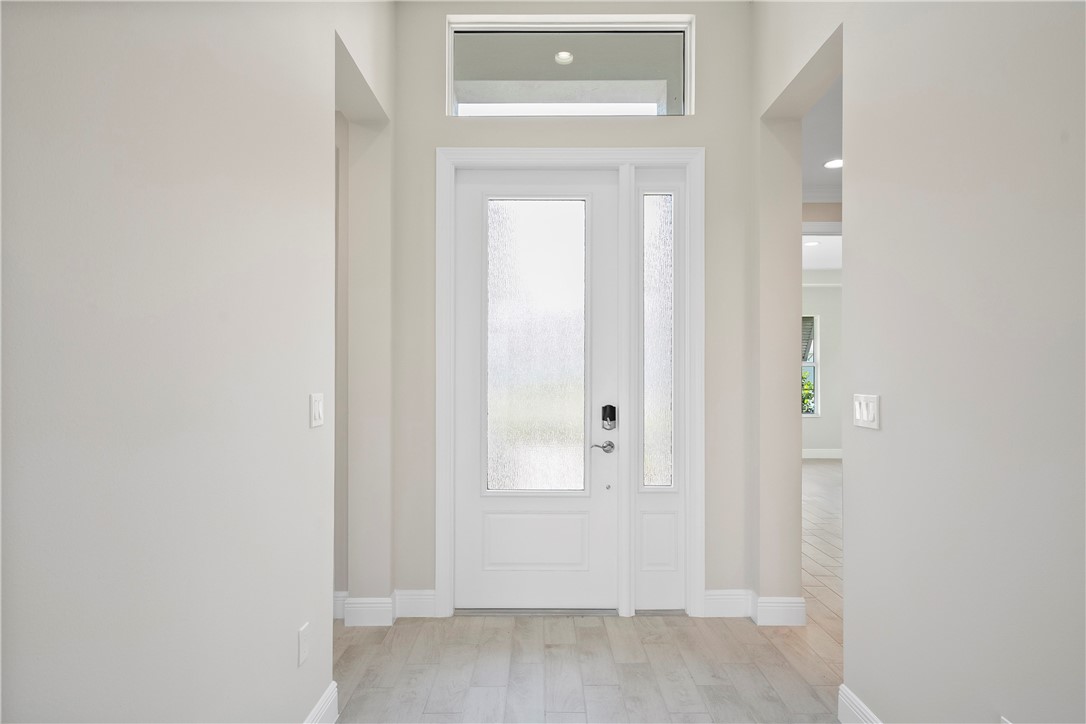 6344 High Pointe Circle Vero Beach, FL 32967 - Photo 11 of 26 a view of a hallway with wooden floor