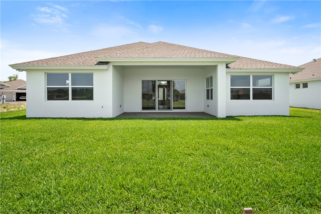 6344 High Pointe Circle Vero Beach, FL 32967 - Photo 23 of 26 a front view of a house with a garden