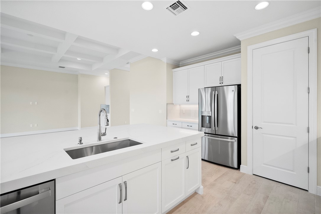 6344 High Pointe Circle Vero Beach, FL 32967 - Photo 3 of 26 a kitchen with refrigerator and cabinets