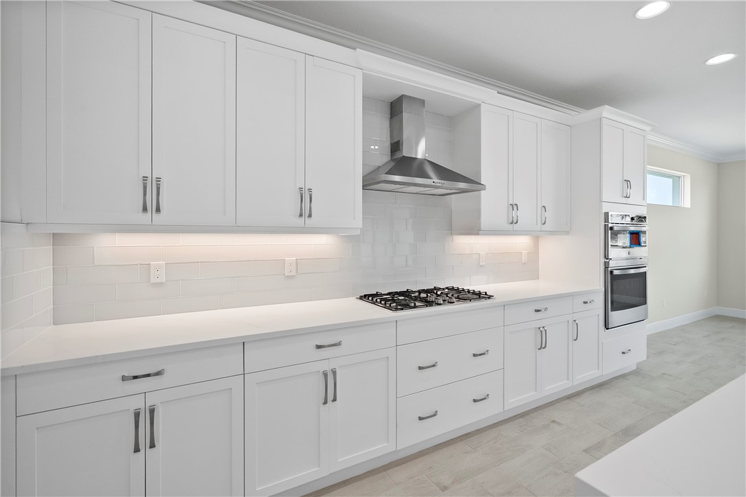 6344 High Pointe Circle Vero Beach, FL 32967 - Photo 4 of 26 a kitchen with white cabinets and a stove top oven