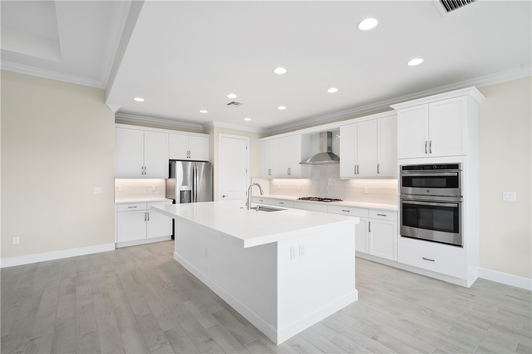 6344 High Pointe Circle Vero Beach, FL 32967 - Photo 7 of 26 a kitchen with a sink a stove top oven and cabinets
