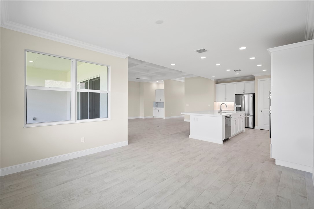 6344 High Pointe Circle Vero Beach, FL 32967 - Photo 8 of 26 a view of a kitchen with furniture and refrigerator