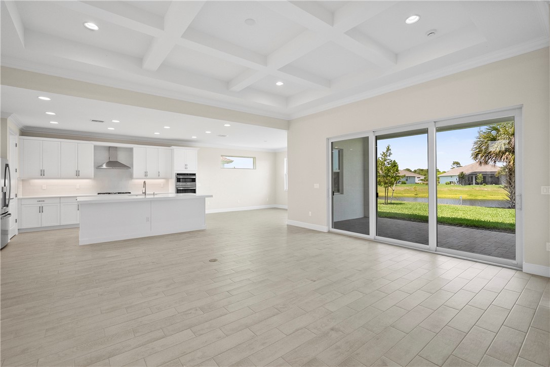 6344 High Pointe Circle Vero Beach, FL 32967 - Photo 9 of 26 a view of an empty room with a window and wooden floor