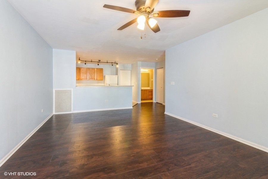 1441 McClure Road, Unit 1441 Aurora, IL 60505 - Photo 2 of 10 a view of an empty room with wooden floor and a window