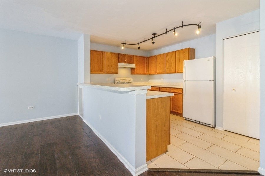 1441 McClure Road, Unit 1441 Aurora, IL 60505 - Photo 4 of 10 a kitchen with a sink a refrigerator and window