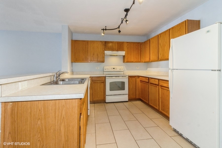 1441 McClure Road, Unit 1441 Aurora, IL 60505 - Photo 5 of 10 a kitchen with a sink appliances and cabinets