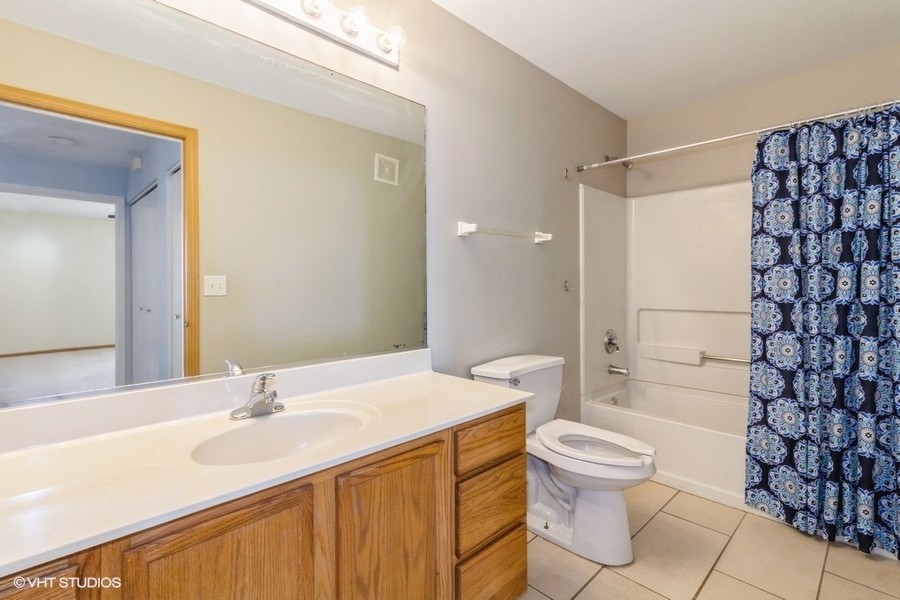 1441 McClure Road, Unit 1441 Aurora, IL 60505 - Photo 9 of 10 a bathroom with a sink toilet vanity and shower