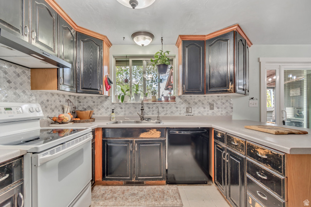 7470 Ramanee Drive Midvale, UT 84047 - Photo 7 of 29 Kitchen featuring electric range, dishwasher, light countertops, a peninsula, and light tile patterned floors