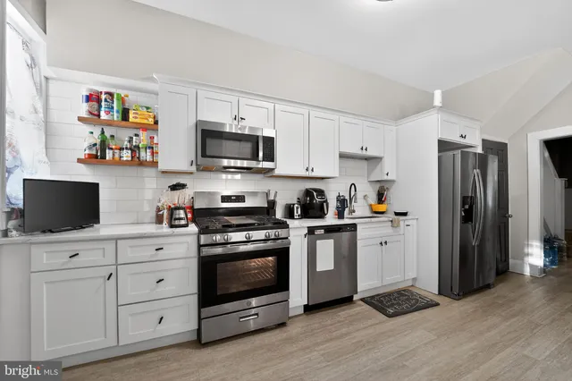 a room with furniture a flat screen tv and a sink