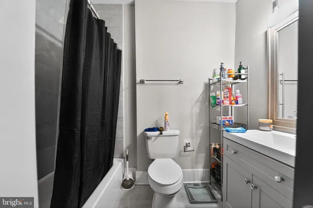 a bathroom with a toilet a sink and a mirror