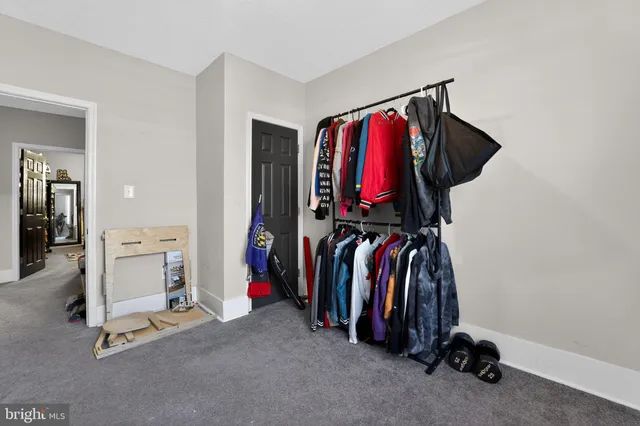a view of a hallway with a livingroom and a bathroom