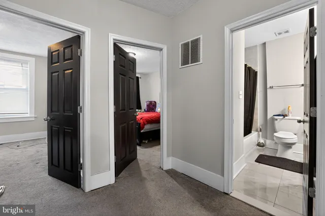 a walk in closet with clothes and shoes