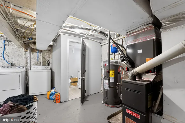 a view of walk in closet with clothes