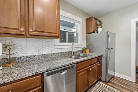 a kitchen with stainless steel appliances granite countertop a sink stove and refrigerator