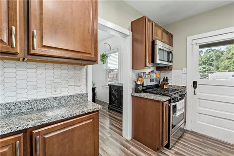 a kitchen with stainless steel appliances granite countertop a stove and a sink