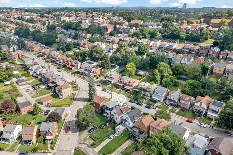 an aerial view of residential houses with outdoor space