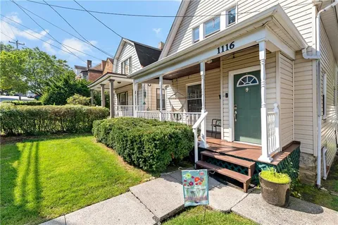 a view of an house with backyard tub and porch with furniture