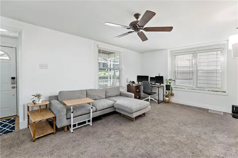 a living room with furniture and a large window