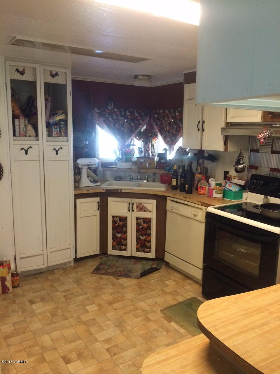2440 Midvale Road Mabton, WA 98935 - Photo 14 of 15 a kitchen with stainless steel appliances granite countertop a stove a sink and a microwave