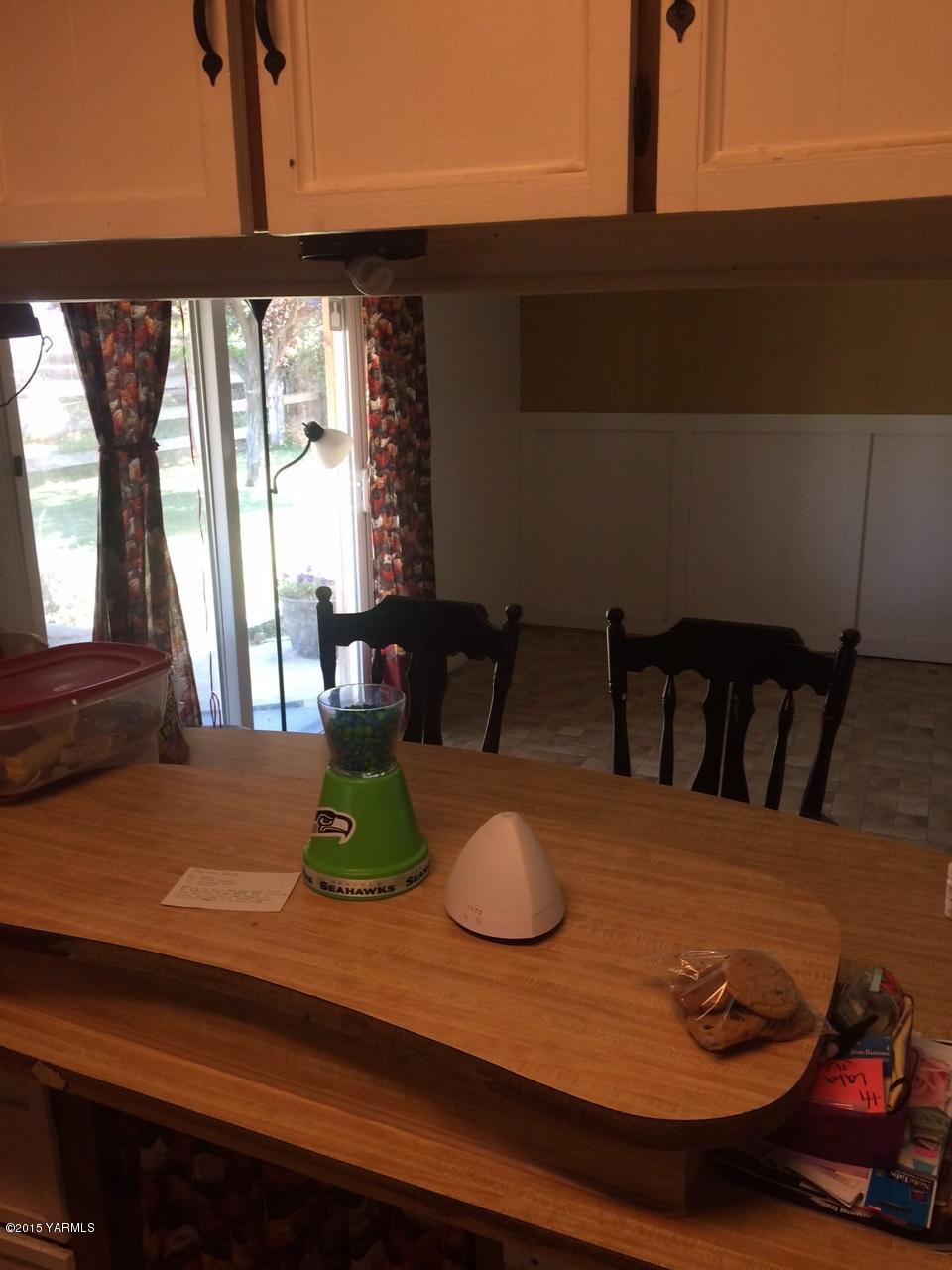 2440 Midvale Road Mabton, WA 98935 - Photo 15 of 15 a view of a dining room with furniture a chandelier and wooden floor