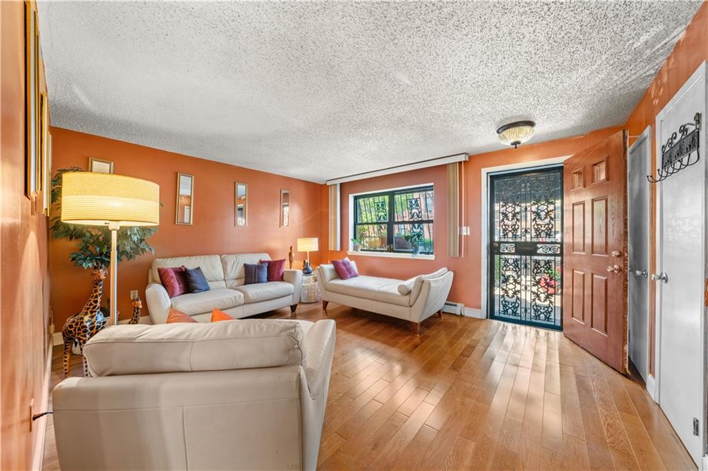 888 Gates Avenue Brooklyn, NY 11221 - Photo 2 of 18 a living room with furniture floor to ceiling window and wooden floor