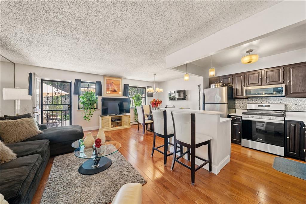 888 Gates Avenue Brooklyn, NY 11221 - Photo 3 of 18 a living room with furniture and a kitchen view
