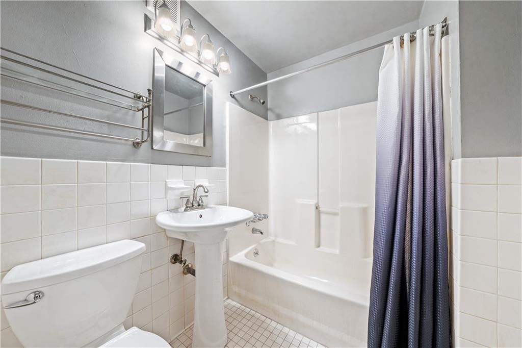 888 Gates Avenue Brooklyn, NY 11221 - Photo 7 of 18 a bathroom with a sink mirror toilet and bathtub