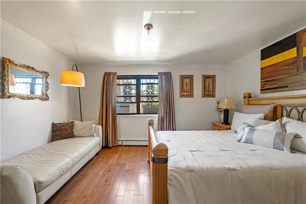 888 Gates Avenue Brooklyn, NY 11221 - Photo 8 of 18 a bedroom with a bed couch and window