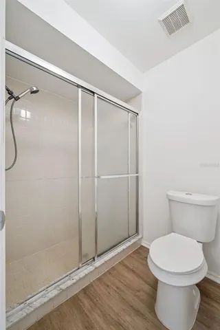 a bathroom with a toilet and a shower