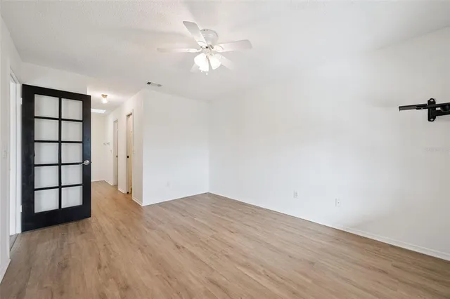 wooden floor in an empty room with a window