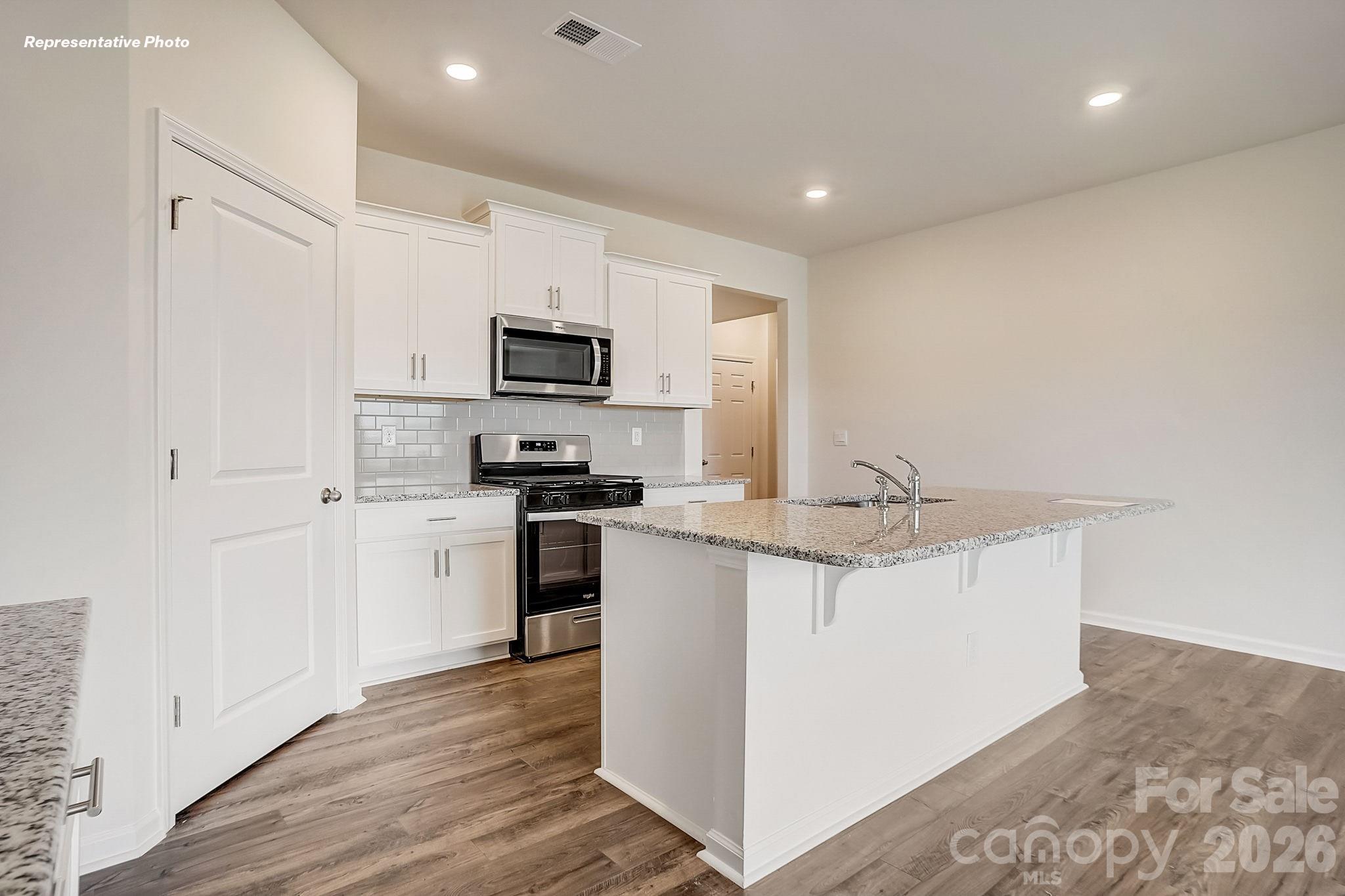 1028 Horizon Lane Chester, SC 29706 - Photo 9 of 24 a kitchen with kitchen island a sink stainless steel appliances and white cabinets