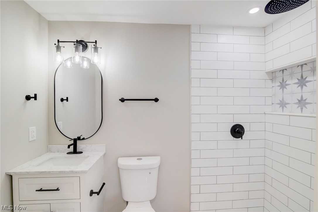 471 Snavely Road Cleveland, OH 44143 - Photo 26 of 35 Bathroom featuring toilet, large vanity, and tiled shower