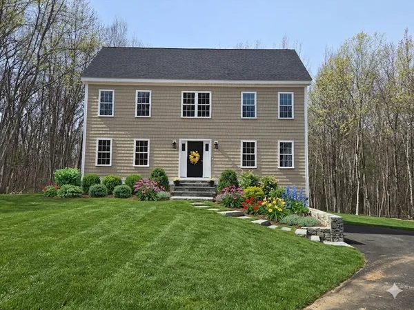 a front view of house with yard and green space