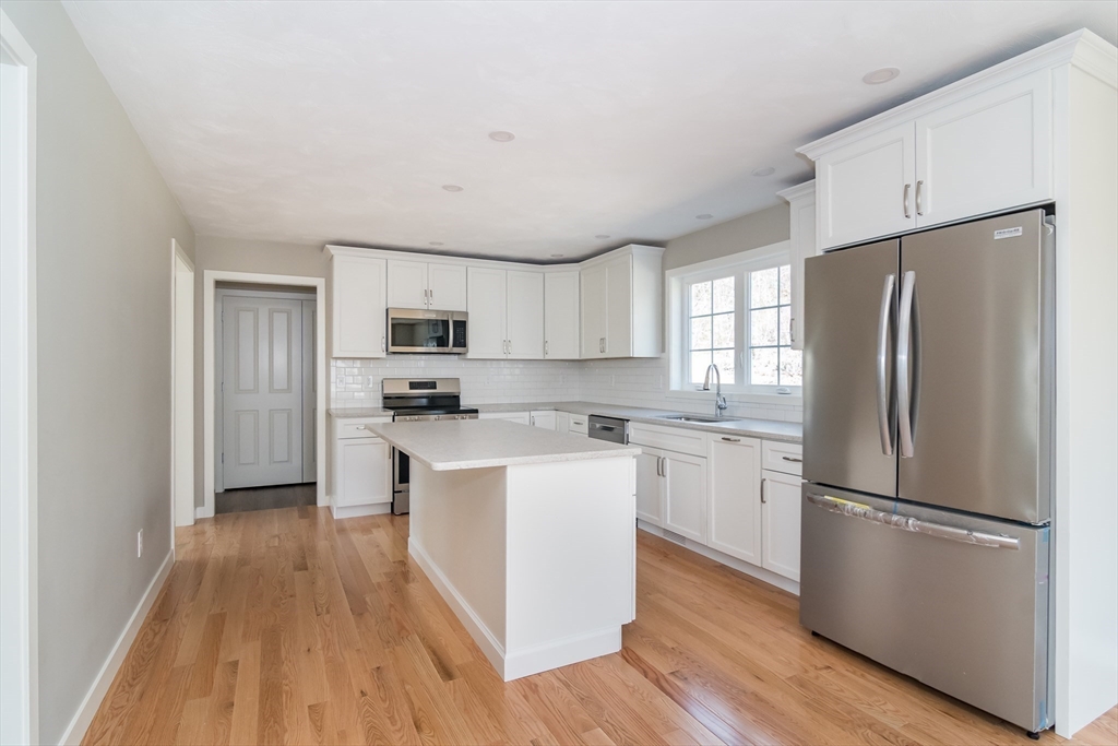41 Martin Road Douglas, MA 01516 - Photo 13 of 32 a kitchen with a refrigerator a sink and dishwasher with wooden floor