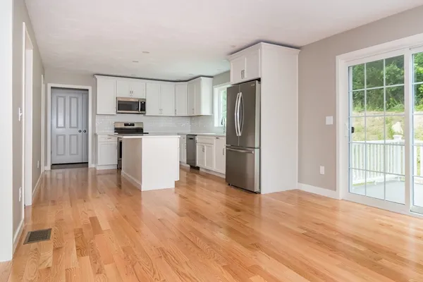 a kitchen with stainless steel appliances a refrigerator and a stove top oven