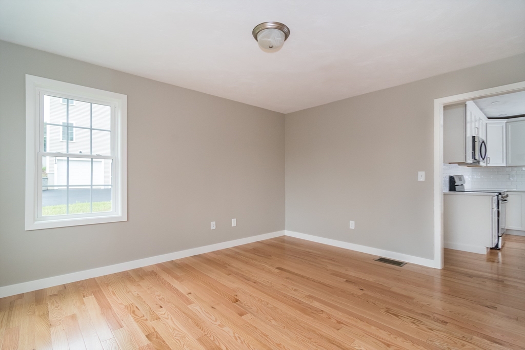 41 Martin Road Douglas, MA 01516 - Photo 21 of 32 an empty room with wooden floor and windows