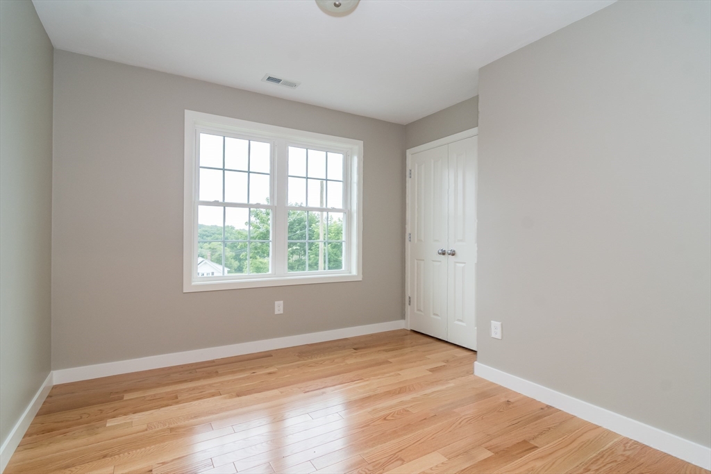 41 Martin Road Douglas, MA 01516 - Photo 27 of 32 an empty room with wooden floor and windows