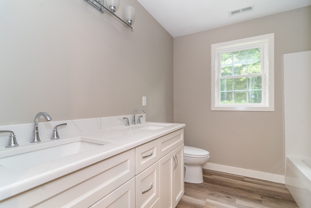 41 Martin Road Douglas, MA 01516 - Photo 28 of 32 a bathroom with a sink a toilet and a window