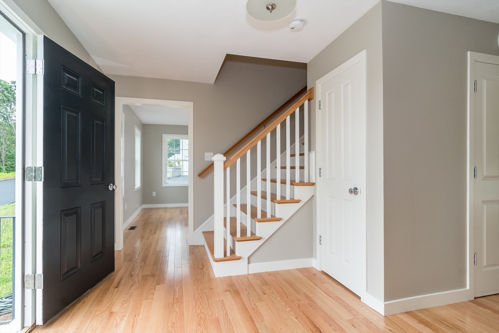 41 Martin Road Douglas, MA 01516 - Photo 3 of 32 a view of front door with wooden floor and stairs