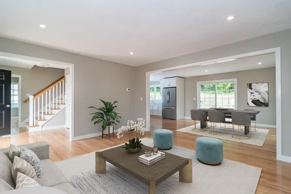 a living room with furniture potted plant and a window