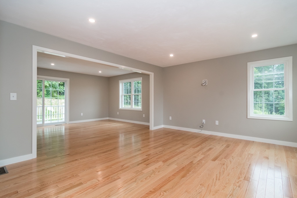 41 Martin Road Douglas, MA 01516 - Photo 7 of 32 an empty room with wooden floor and windows