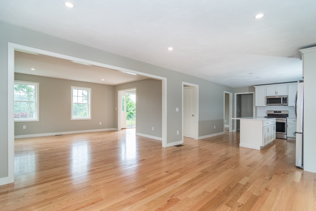 41 Martin Road Douglas, MA 01516 - Photo 9 of 32 a view of a big room with wooden floor and windows