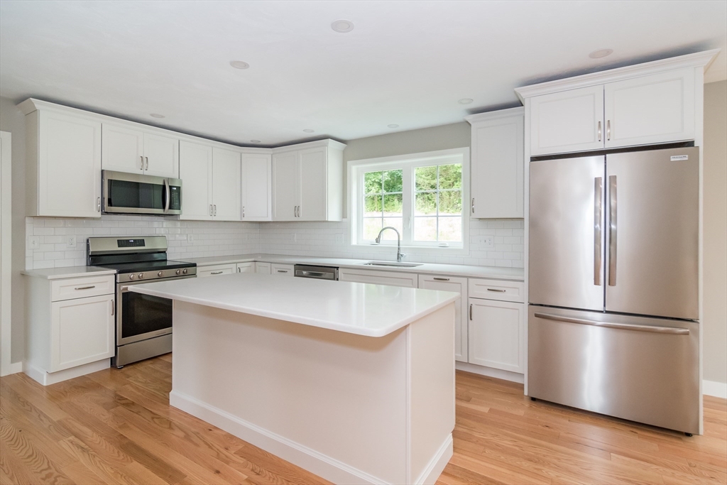 41 Martin Road Douglas, MA 01516 - Photo 10 of 32 a kitchen with appliances a sink cabinets and a window