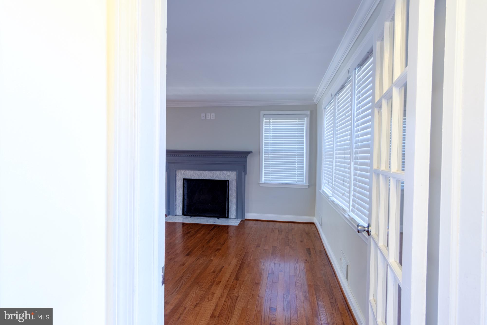 8501 Pleasant Plains Road Baltimore, MD 21286 - Photo 18 of 53 a view of an empty room with wooden floor and a window