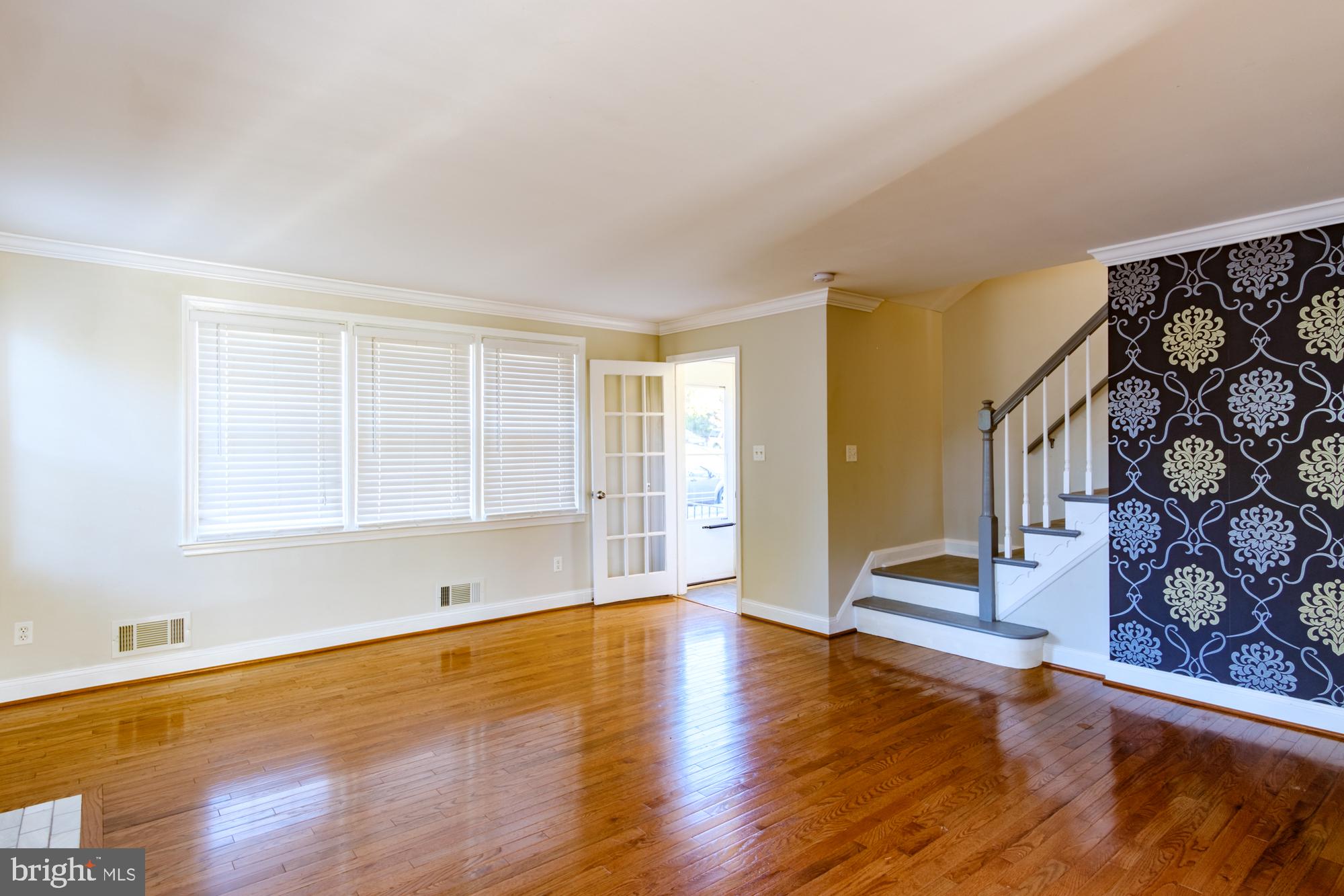 8501 Pleasant Plains Road Baltimore, MD 21286 - Photo 21 of 53 a view of an empty room with wooden floor and a window