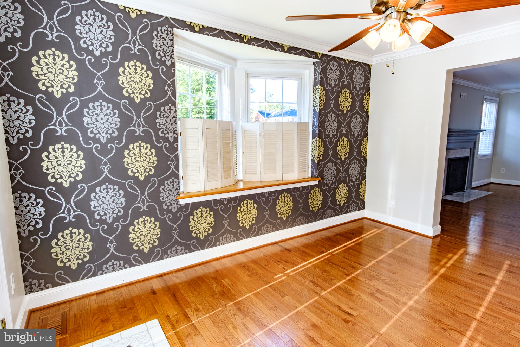 8501 Pleasant Plains Road Baltimore, MD 21286 - Photo 23 of 53 a view of a livingroom with wooden floor and a ceiling fan