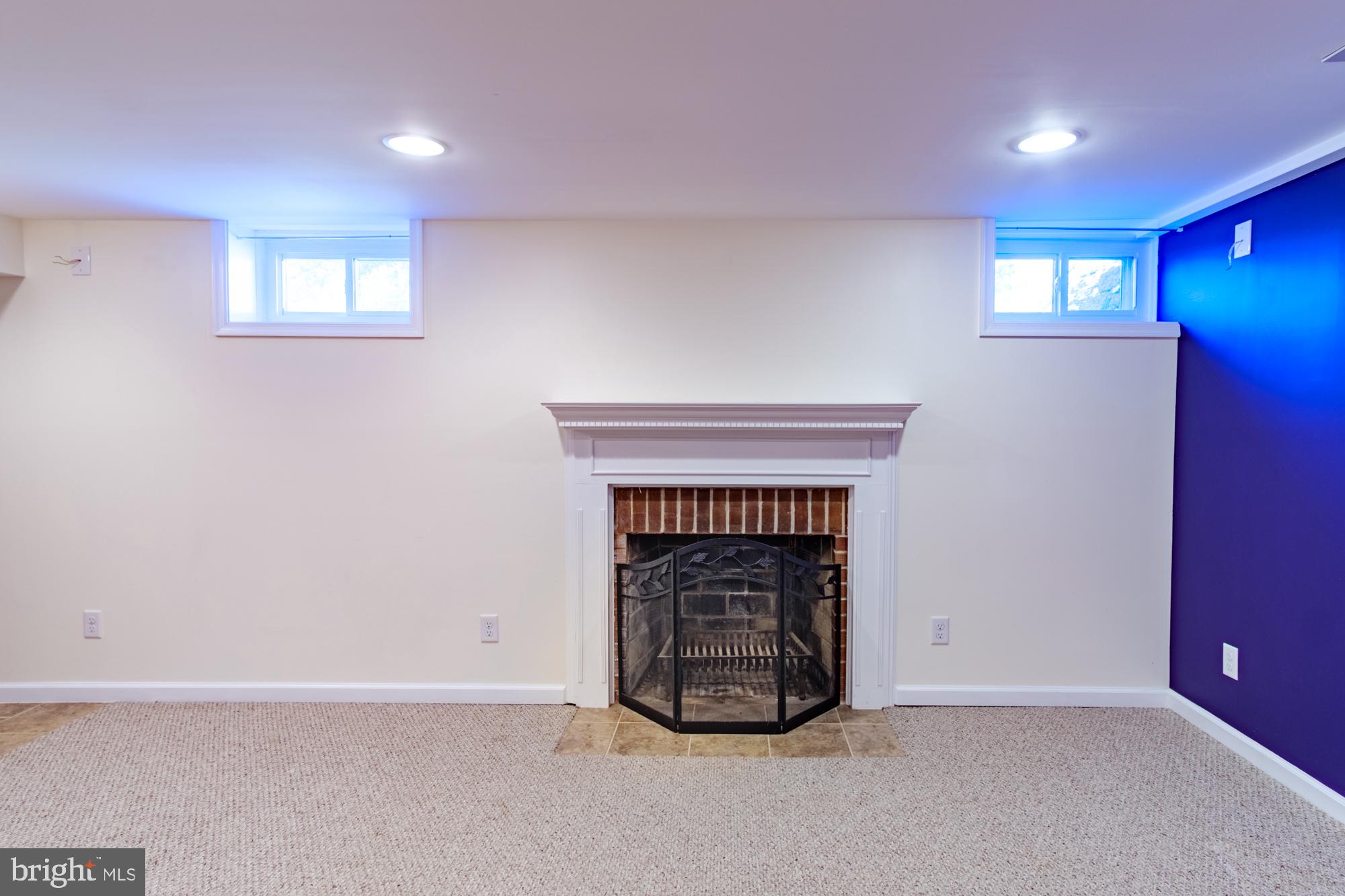 8501 Pleasant Plains Road Baltimore, MD 21286 - Photo 34 of 53 an empty room with windows and fireplace