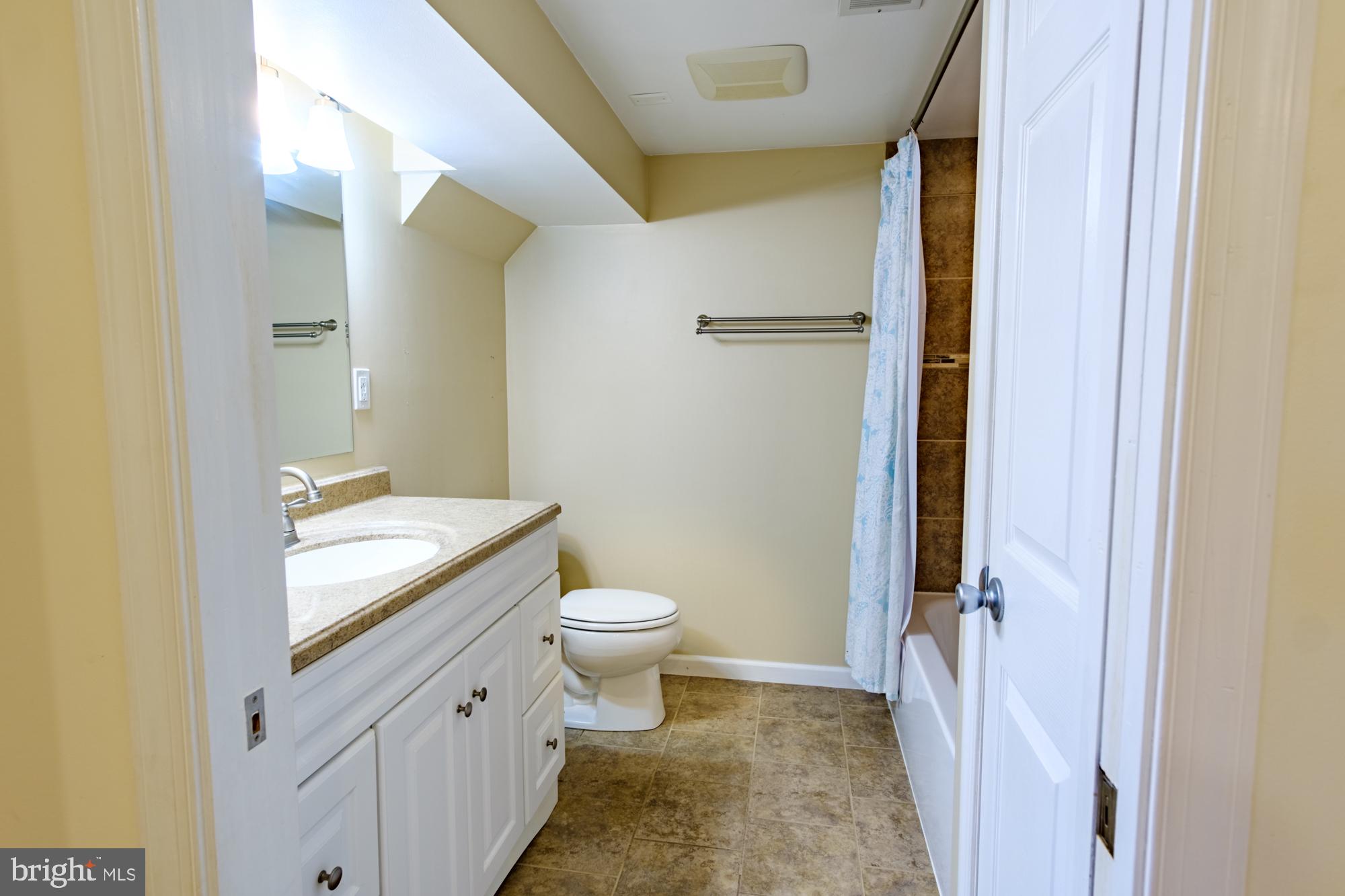 8501 Pleasant Plains Road Baltimore, MD 21286 - Photo 37 of 53 a bathroom with a granite countertop toilet a sink and a mirror